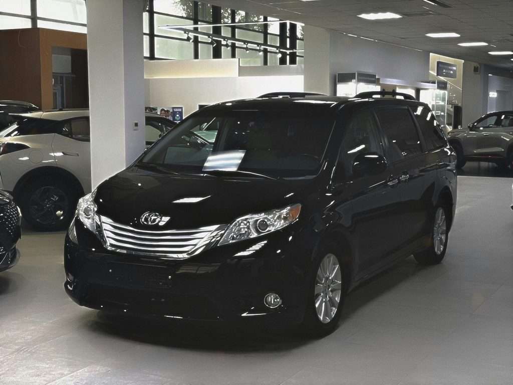 Pre-owned black minivan at Ideal Auto Bensonhurst, Brooklyn showroom