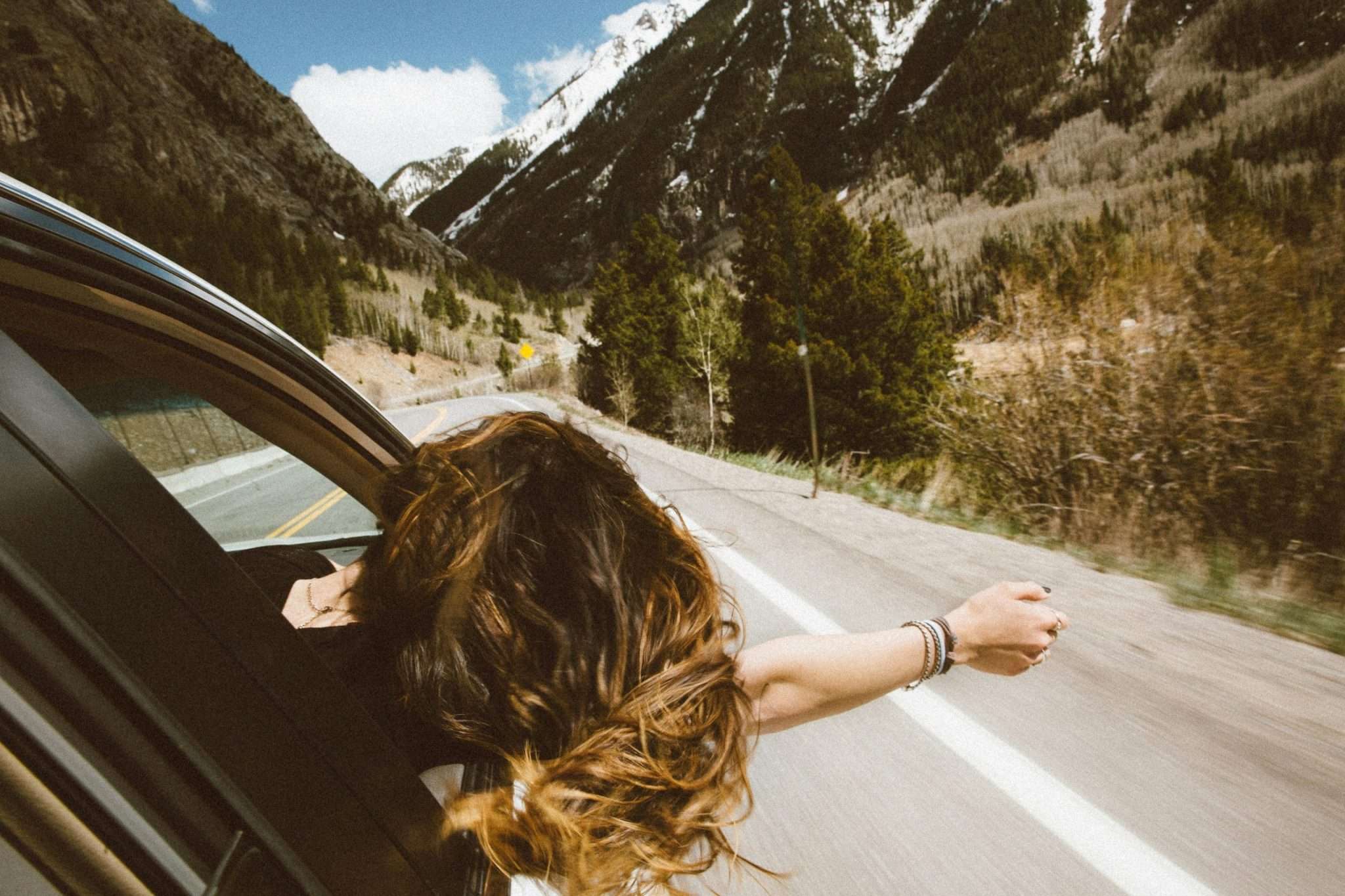 Person enjoying road trip in a car, ideal auto bensonhurst, pre owned car brooklyn