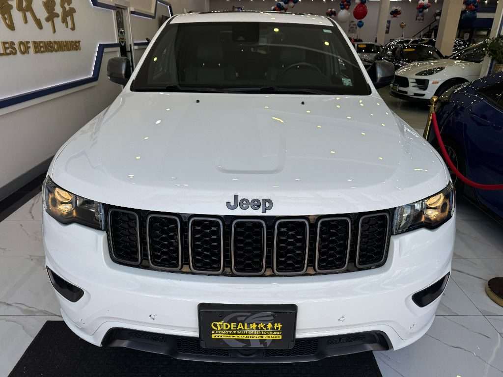 Front view of a white Jeep at Ideal Auto Bensonhurst, pre owned car Brooklyn