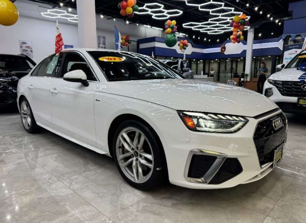 White sedan at Ideal Auto Bensonhurst, pre owned car Brooklyn dealership.
