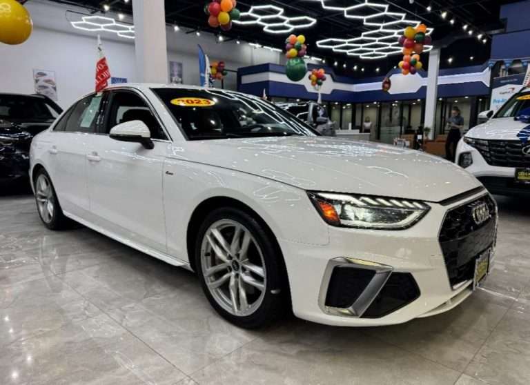 White sedan at Ideal Auto Bensonhurst, pre owned car Brooklyn dealership.