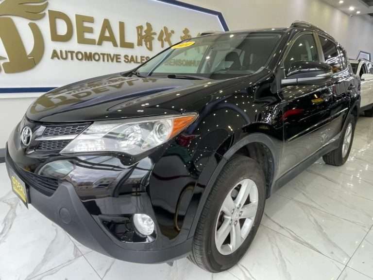 2014 Toyota RAV4 XLE black compact SUV displayed inside a used car dealership showroom in Bensonhurst Brooklyn