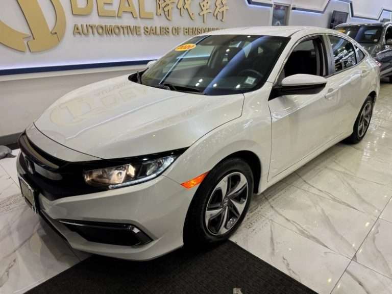 2020 Honda Civic white sedan inside a car dealership showroom in Brooklyn